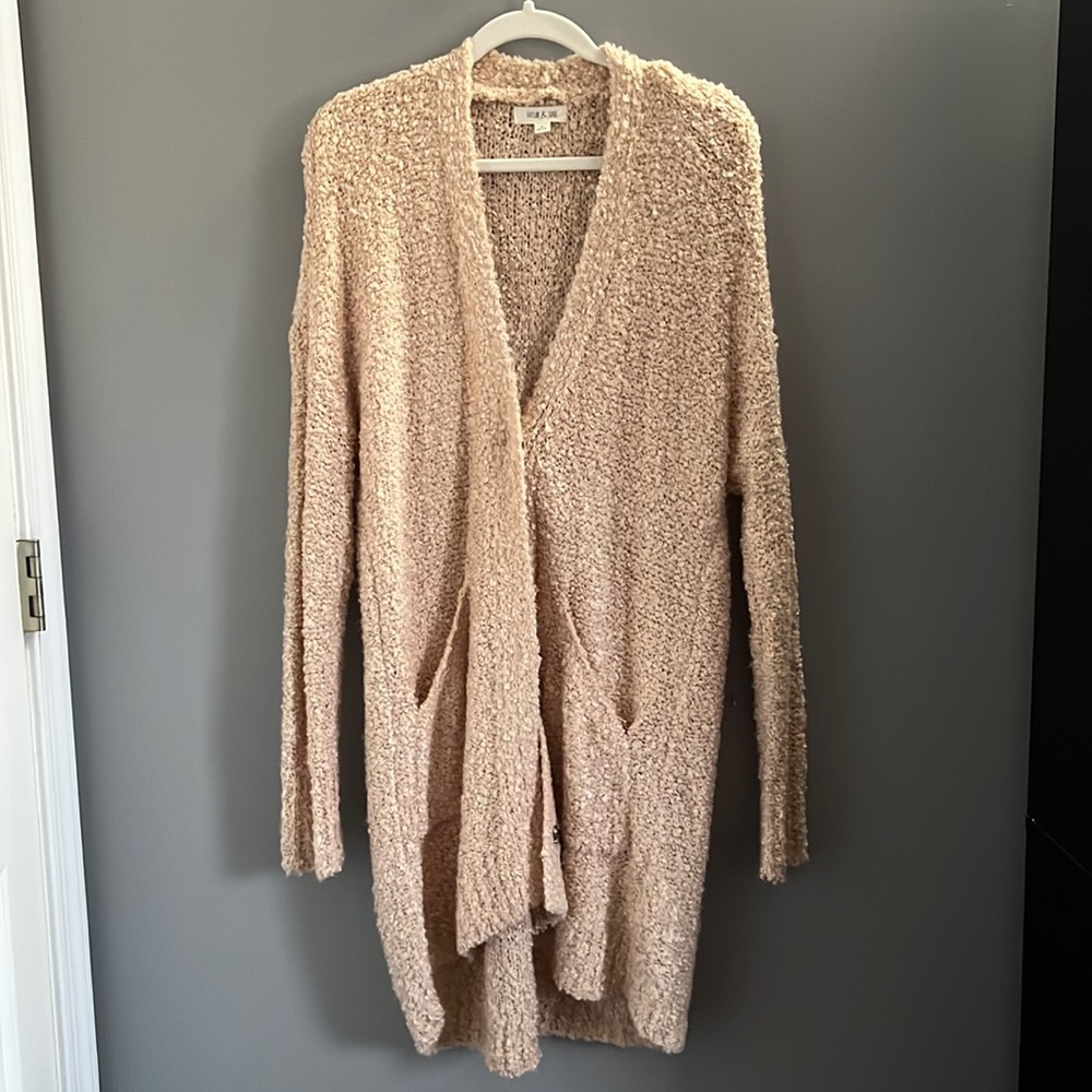 Light pink cardigan sweater with pockets.